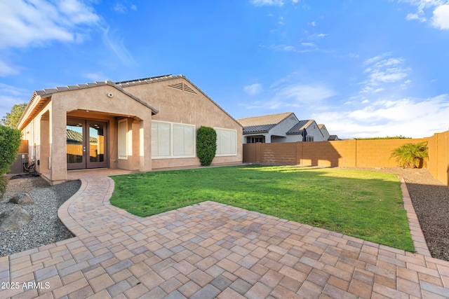 25969 W Tina Ln, Buckeye, AZ 85396 - rear view of house featuring french doors, a patio area, stucco siding, and a fenced backyard