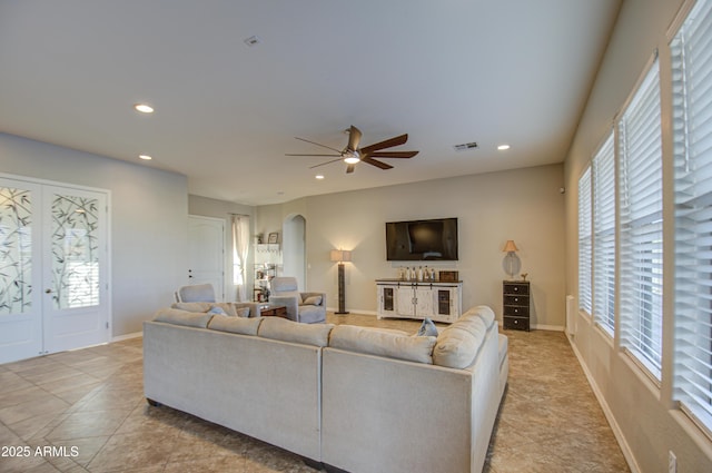 living room featuring visible vents, arched walkways, and recessed lighting