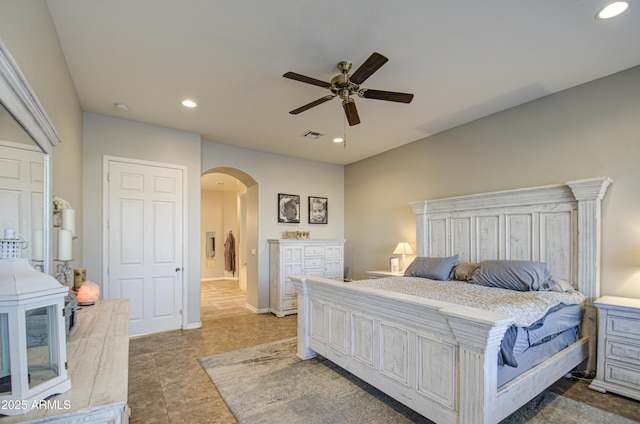 bedroom with a ceiling fan, arched walkways, visible vents, and recessed lighting