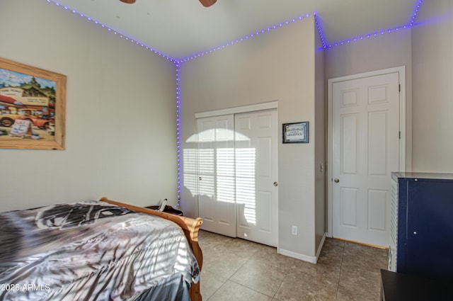 bedroom with baseboards, a closet, and tile patterned floors