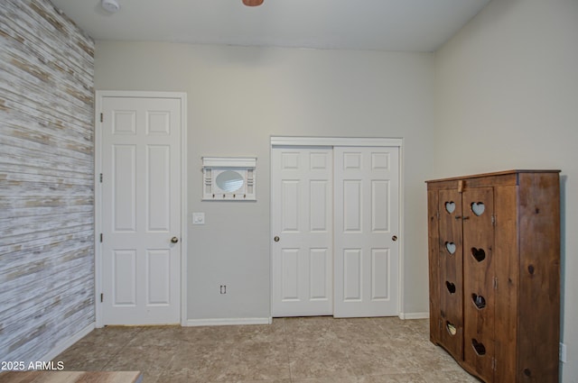 unfurnished bedroom featuring a closet and baseboards