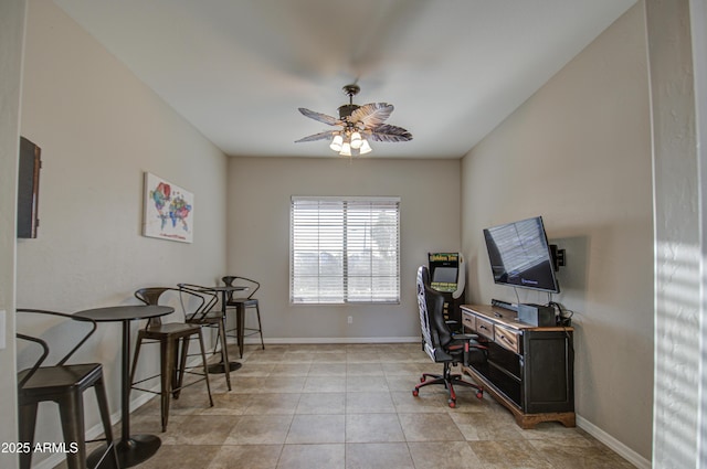 office area featuring tile patterned floors, a ceiling fan, and baseboards