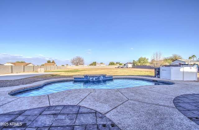 view of swimming pool with a patio area, a fenced backyard, a fenced in pool, and a hot tub