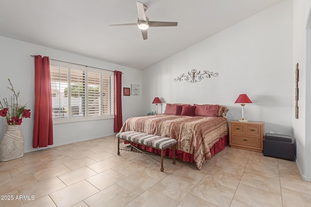 bedroom featuring a ceiling fan, vaulted ceiling, baseboards, and light tile patterned floors