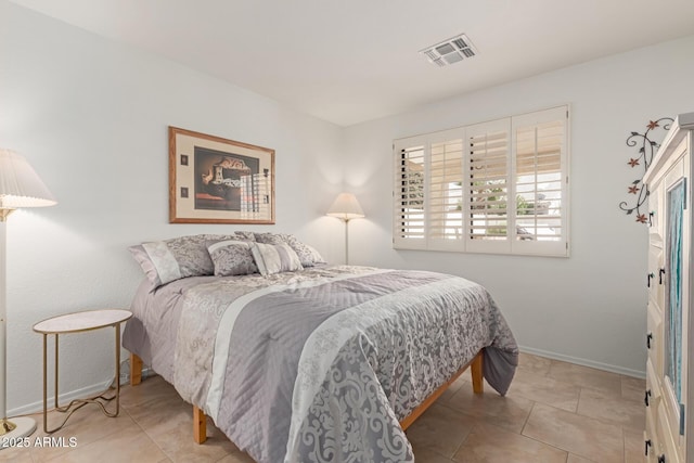 bedroom featuring tile patterned flooring, visible vents, and baseboards