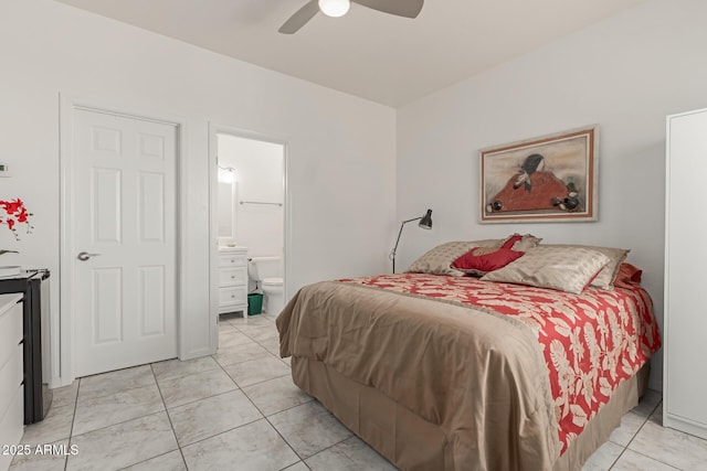 bedroom featuring light tile patterned flooring, ceiling fan, and ensuite bath