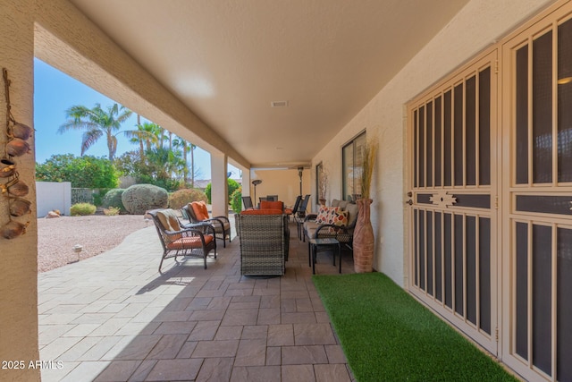 view of patio with visible vents, fence, and an outdoor living space