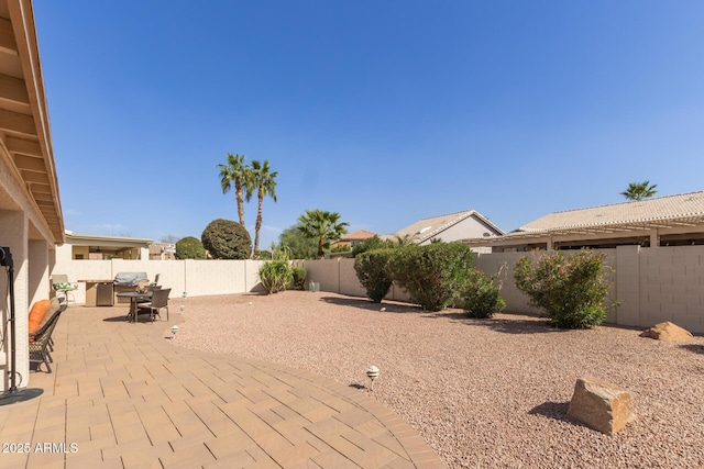 view of patio featuring outdoor dining area and a fenced backyard