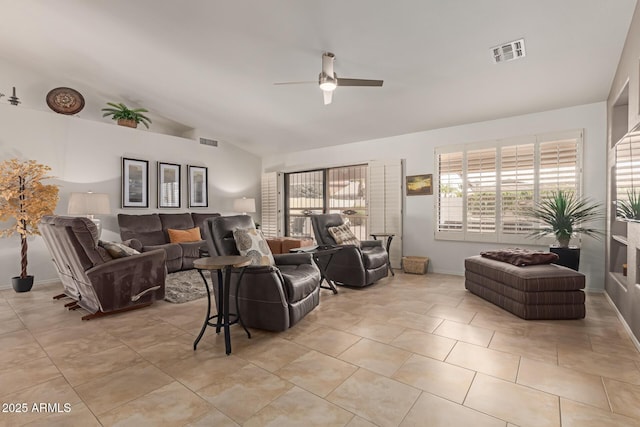 living area featuring ceiling fan, visible vents, vaulted ceiling, and light tile patterned flooring