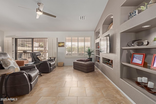 living room with baseboards, visible vents, a ceiling fan, tile patterned flooring, and built in shelves