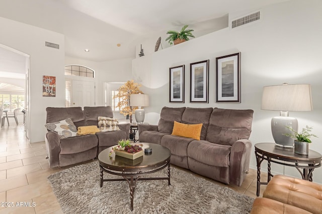 tiled living room featuring visible vents