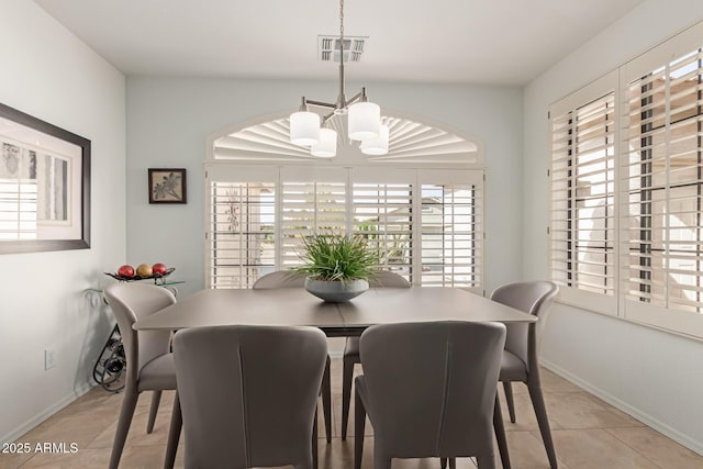 dining room featuring baseboards, light tile patterned floors, and an inviting chandelier