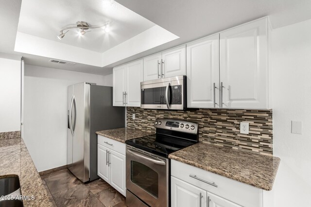714 E Morningside Dr, Phoenix, AZ 85022 - kitchen featuring white cabinets, visible vents, a raised ceiling, tasteful backsplash, and appliances with stainless steel finishes
