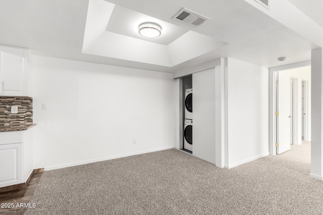 714 E Morningside Dr, Phoenix, AZ 85022 - below grade area with baseboards, visible vents, dark colored carpet, and stacked washer / drying machine
