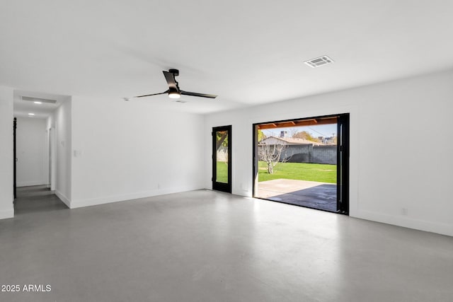 empty room with visible vents, a ceiling fan, concrete floors, and baseboards