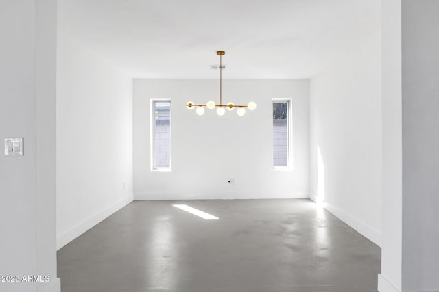 unfurnished dining area featuring baseboards, visible vents, a chandelier, and finished concrete floors