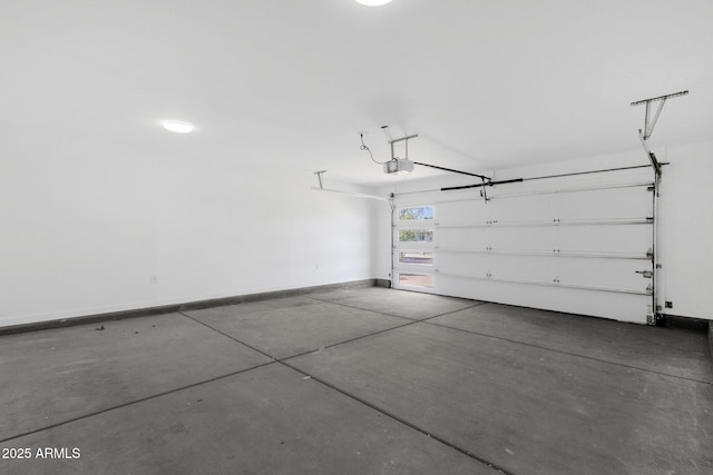 garage featuring a garage door opener and baseboards