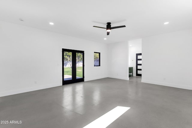 spare room featuring recessed lighting, french doors, baseboards, and concrete floors