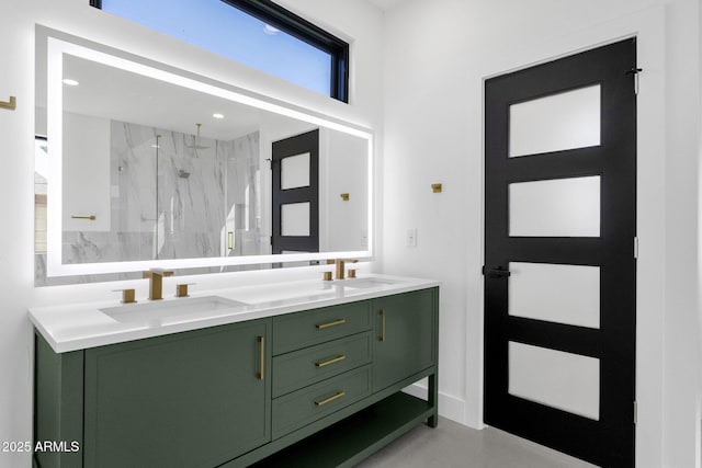 full bathroom featuring a sink, a marble finish shower, recessed lighting, and double vanity