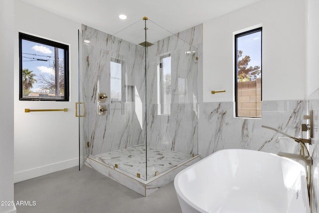 bathroom featuring recessed lighting, baseboards, a marble finish shower, and a freestanding bath