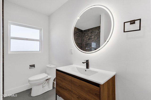 bathroom featuring toilet and vanity