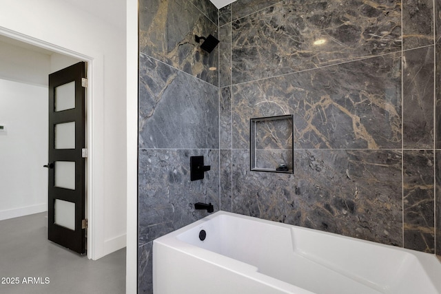 bathroom featuring finished concrete flooring and baseboards