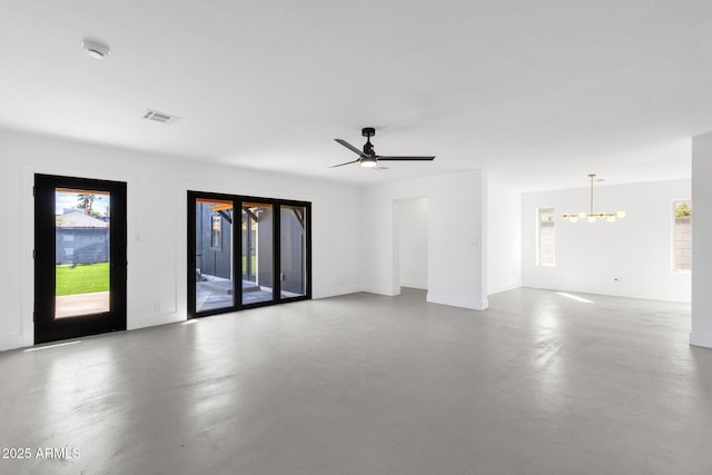 empty room featuring ceiling fan with notable chandelier, visible vents, and concrete flooring