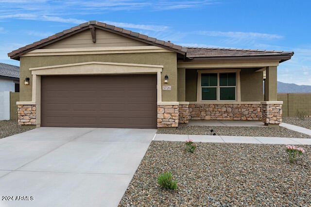 view of front facade with a mountain view and a garage