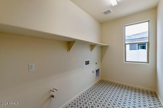 clothes washing area featuring hookup for a washing machine, gas dryer hookup, and electric dryer hookup