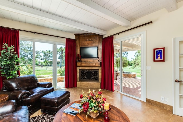 living area with beamed ceiling, plenty of natural light, and baseboards