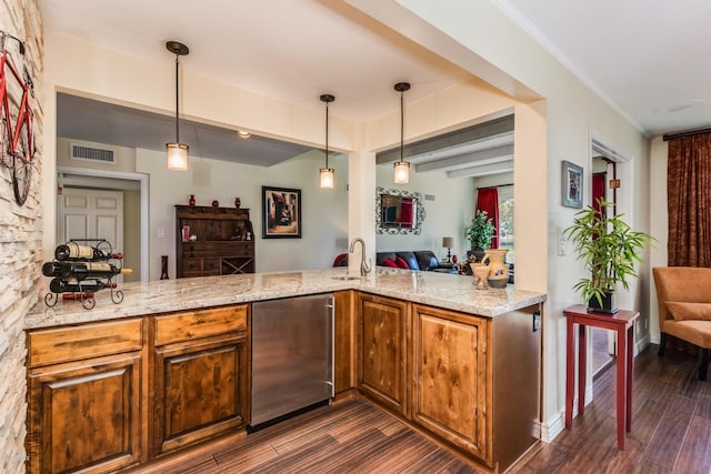 kitchen with dark wood-style floors, light stone countertops, refrigerator, and open floor plan