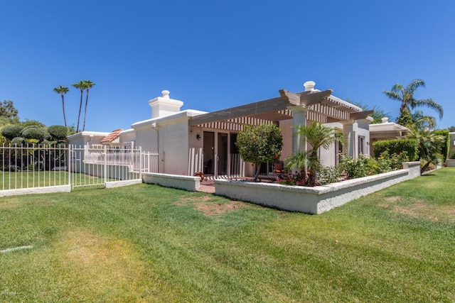 rear view of property with a yard, fence, a pergola, and stucco siding