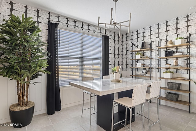 dining space with light tile patterned floors and a textured ceiling