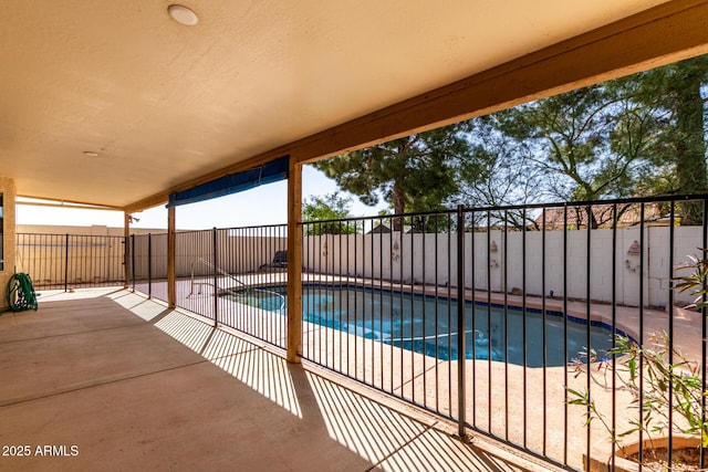 view of swimming pool with a patio area, fence, and a fenced in pool