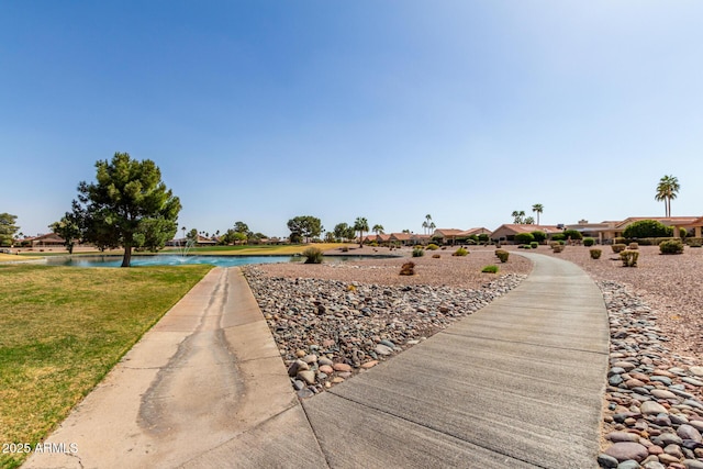 view of community featuring a water view and a lawn