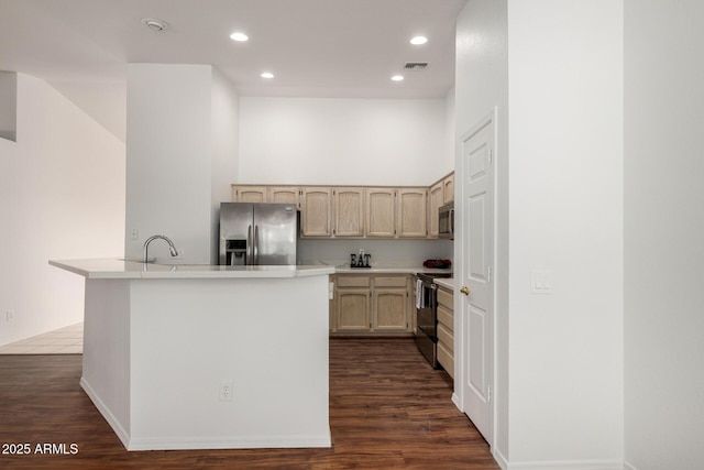 kitchen with visible vents, dark wood-style floors, stainless steel appliances, light countertops, and light brown cabinets