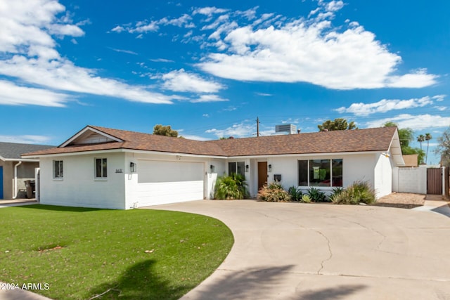 ranch-style house featuring a garage and a front yard