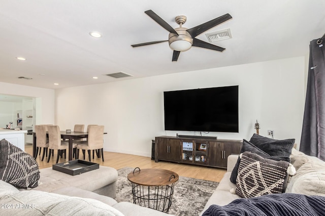 living room with ceiling fan and light hardwood / wood-style floors