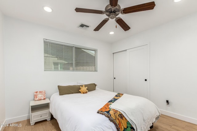 bedroom with ceiling fan, a closet, and light wood-type flooring