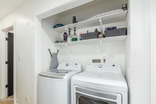 clothes washing area featuring washing machine and clothes dryer