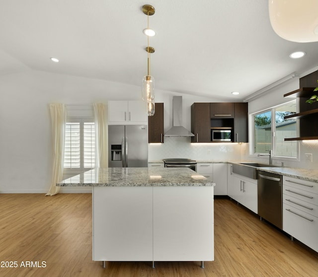 6833 E Grandview Dr, Scottsdale, AZ 85254 - kitchen with tasteful backsplash, wall chimney range hood, light wood-style flooring, and appliances with stainless steel finishes
