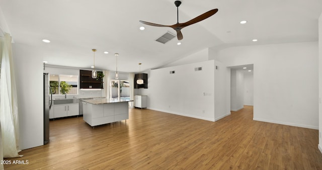 6833 E Grandview Dr, Scottsdale, AZ 85254 - kitchen with recessed lighting, a kitchen island, visible vents, lofted ceiling, and ceiling fan