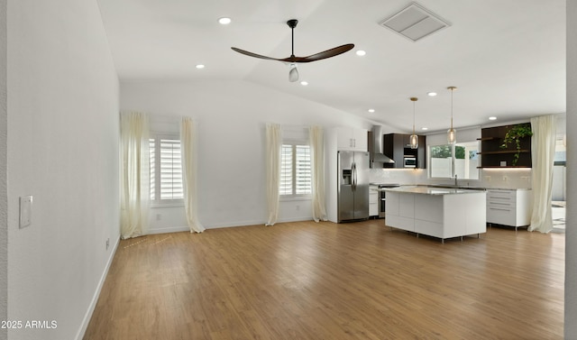 6833 E Grandview Dr, Scottsdale, AZ 85254 - kitchen with light countertops, a healthy amount of sunlight, open shelves, and stainless steel appliances