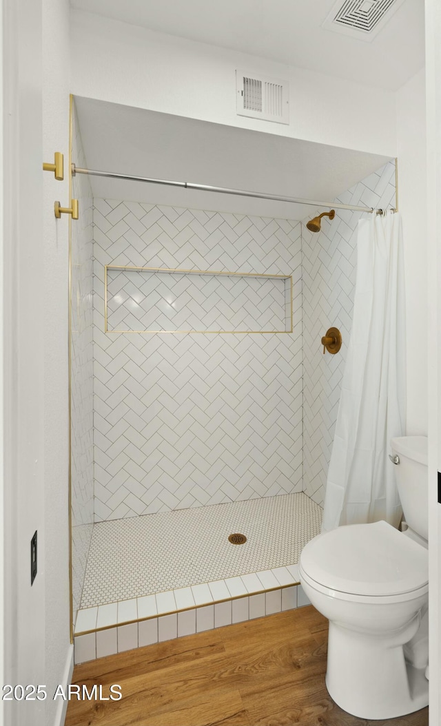 6833 E Grandview Dr, Scottsdale, AZ 85254 - full bath with toilet, visible vents, a stall shower, and wood finished floors