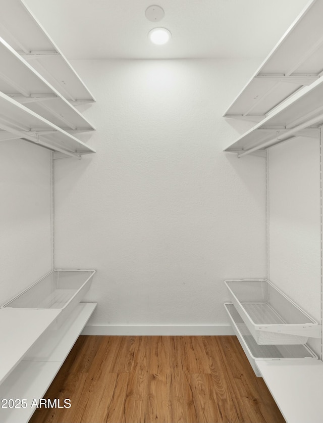 6833 E Grandview Dr, Scottsdale, AZ 85254 - walk in closet featuring wood finished floors