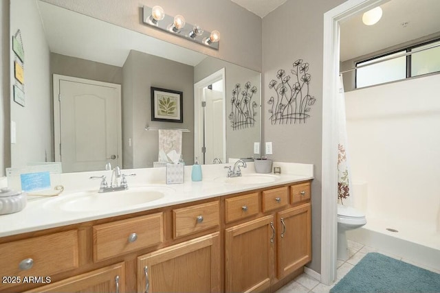 bathroom with tile patterned flooring, vanity, a shower with shower curtain, and toilet