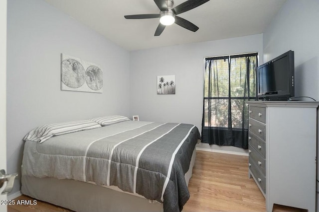 bedroom with ceiling fan and light hardwood / wood-style floors