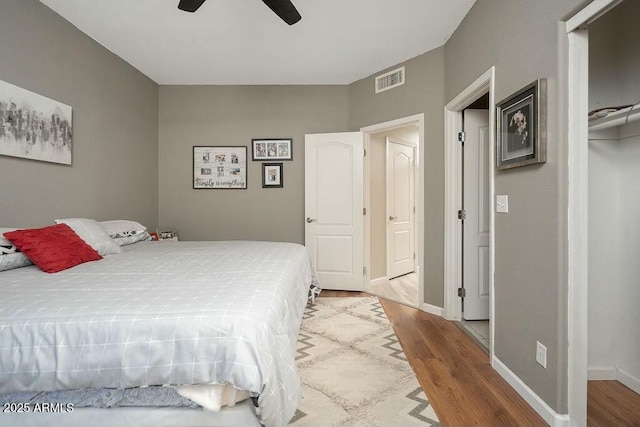 bedroom with wood-type flooring and ceiling fan