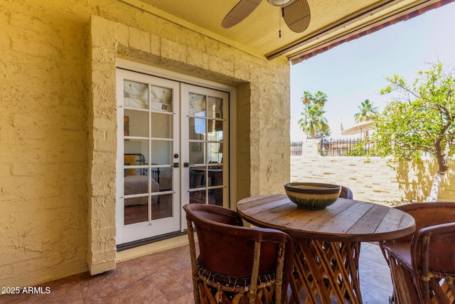 1235 N Sunnyvale Unit 113, Mesa, AZ 85205 - dining area with ceiling fan, french doors, a textured wall, and stone finish floors