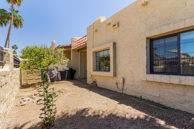 1235 N Sunnyvale Unit 113, Mesa, AZ 85205 - view of side of property with stucco siding and a tiled roof